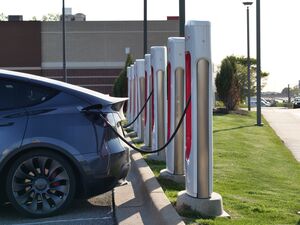 Coche eléctrico conectado a un punto de recarga, relacionado con el balanceo dinámico de carga.